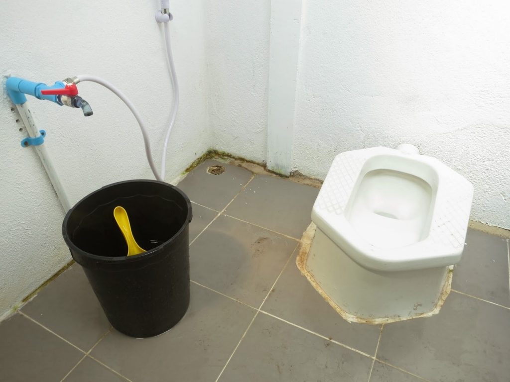 squat toilet with bucket