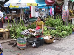 lady at local market on mobile phone Yangon